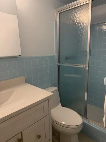 a bathroom with a toilet and a shower