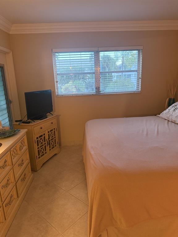 2050 Northeast 39th Street, Unit 211W Lighthouse Point, FL 33064 - Photo 16 of 30 a bedroom with a bed and furniture