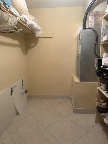 a view of storage and utility room with racks on the wall