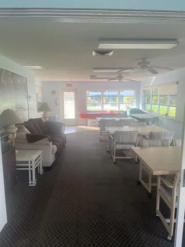 a room with a table chairs and a wooden floor