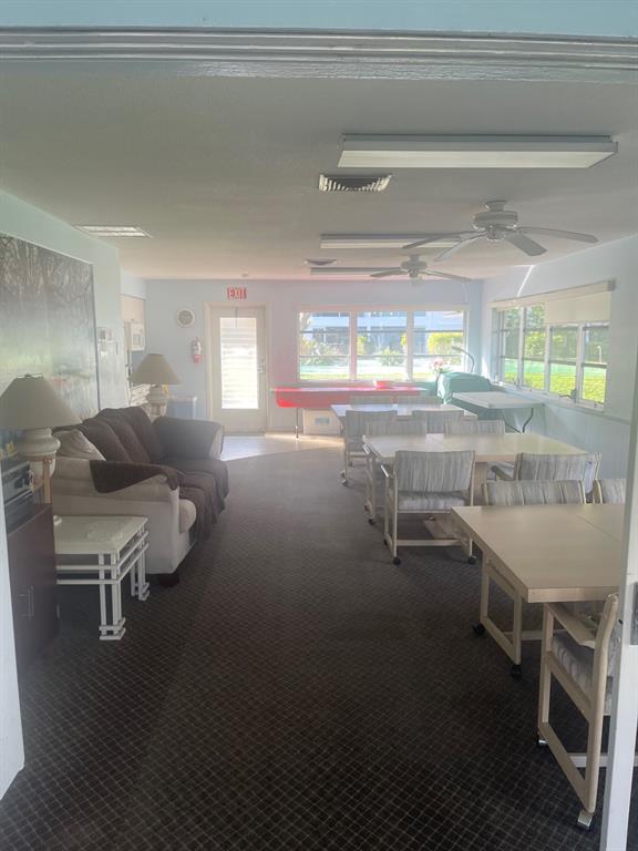 2050 Northeast 39th Street, Unit 211W Lighthouse Point, FL 33064 - Photo 29 of 30 a room with a table chairs and a wooden floor