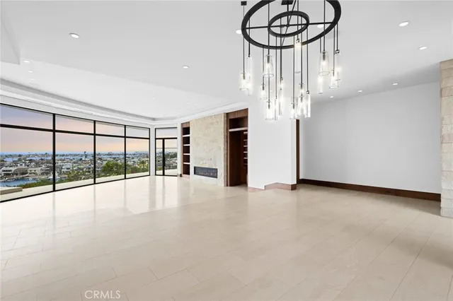 a view of empty room with stairs and wooden floor