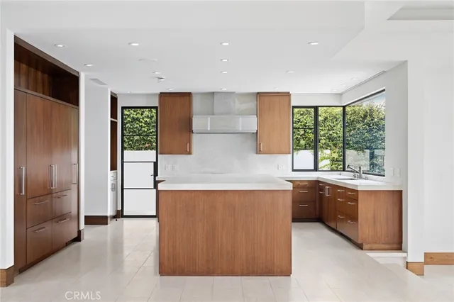 a kitchen with stainless steel appliances granite countertop a refrigerator and a stove top oven
