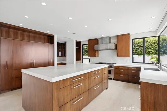a large kitchen with stainless steel appliances a sink dishwasher stove and refrigerator