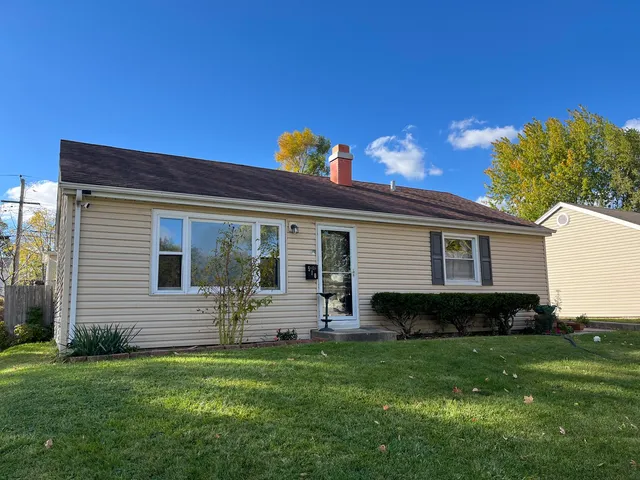 a front view of house with yard and outdoor seating