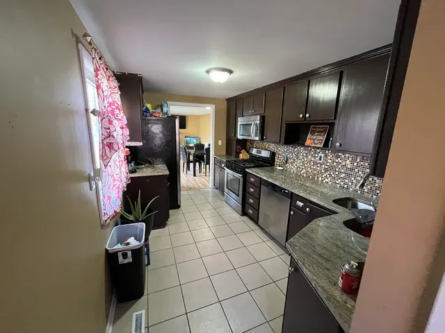 a kitchen with a stove and a refrigerator