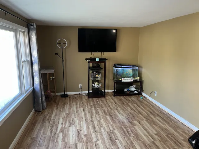 a view of room with window and flat screen tv