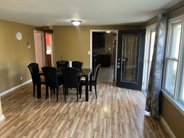 a view of a dining room with furniture and wooden floor