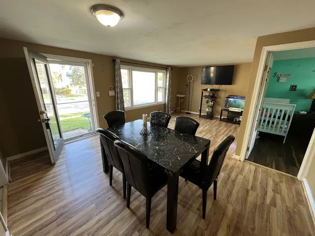 a view of a dining room with furniture window and wooden floor