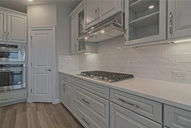 a kitchen with counter top space cabinets and wooden floor
