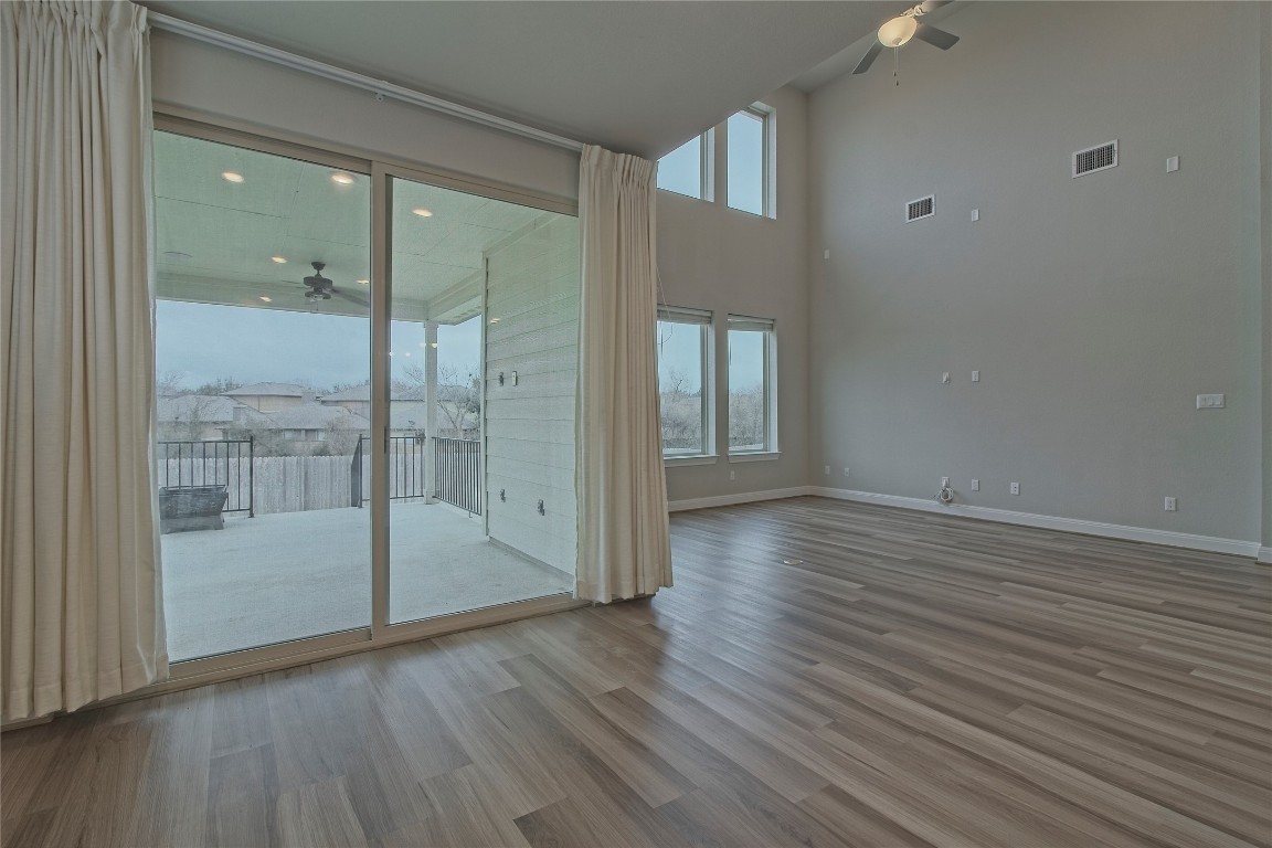 324 Windom Way Georgetown, TX 78626 - Photo 11 of 40 Spare room with a ceiling fan, plenty of natural light, light wood finished floors, and a high ceiling