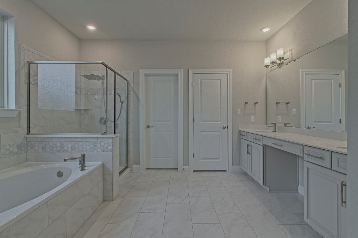 324 Windom Way Georgetown, TX 78626 - Photo 17 of 40 Full bath with a shower stall, vanity, and a garden tub