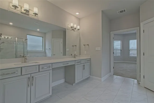 a spacious bathroom with a tub shower and sink