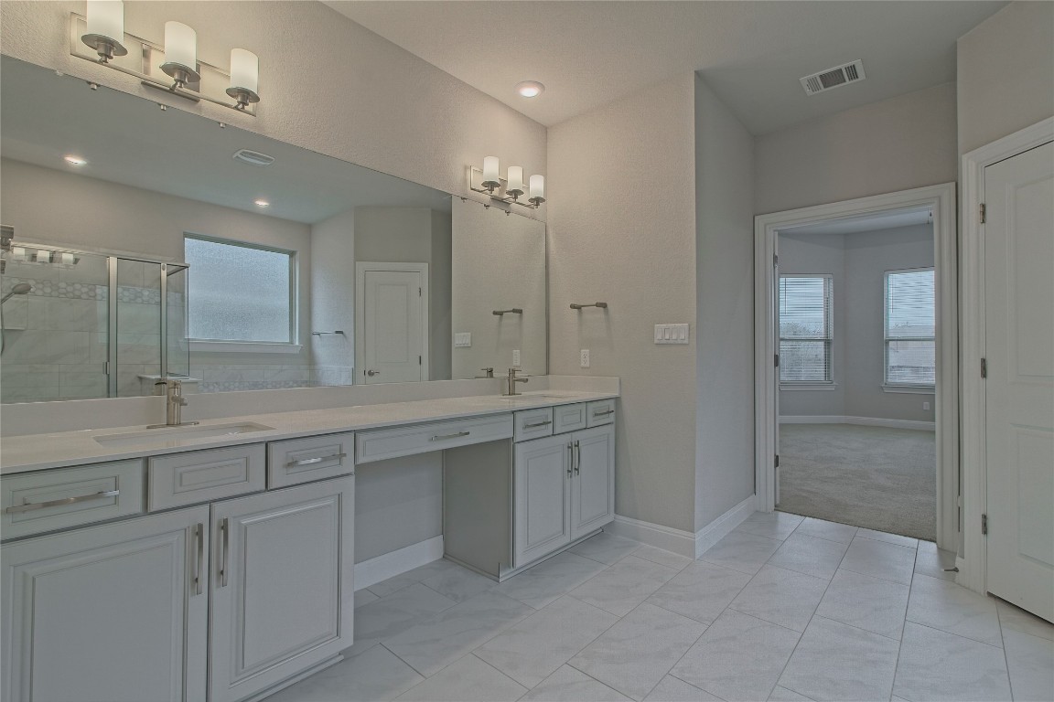 324 Windom Way Georgetown, TX 78626 - Photo 18 of 40 Bathroom featuring double vanity and a shower stall