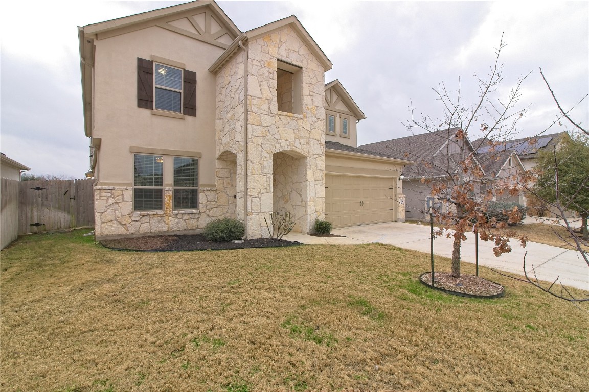 324 Windom Way Georgetown, TX 78626 - Photo 2 of 40 View of front of home featuring stone siding, driveway, stucco siding, and a garage