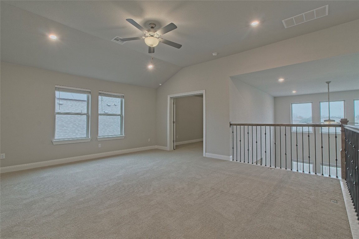 324 Windom Way Georgetown, TX 78626 - Photo 23 of 40 Carpeted empty room with a ceiling fan, lofted ceiling, and recessed lighting