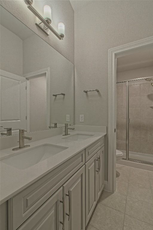 324 Windom Way Georgetown, TX 78626 - Photo 26 of 40 Full bath with double vanity, a shower stall, and light tile patterned floors