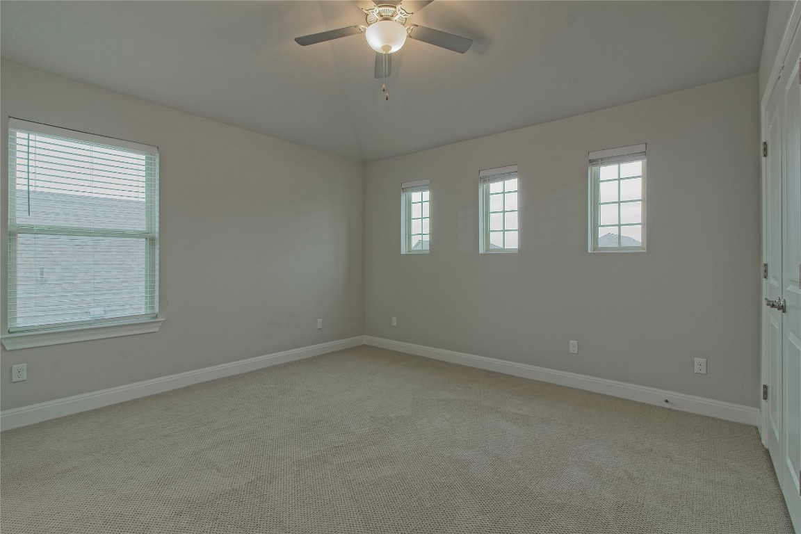 324 Windom Way Georgetown, TX 78626 - Photo 27 of 40 Unfurnished room with light carpet, ceiling fan, and lofted ceiling