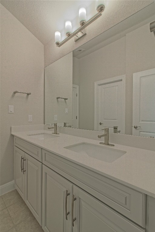 324 Windom Way Georgetown, TX 78626 - Photo 28 of 40 Full bathroom featuring double vanity and a textured ceiling
