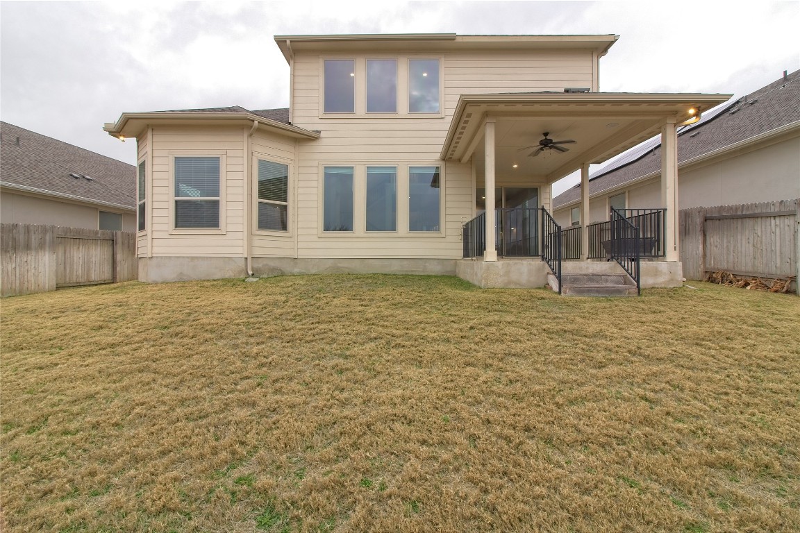 324 Windom Way Georgetown, TX 78626 - Photo 30 of 40 Back of house with ceiling fan, a fenced backyard, and a patio
