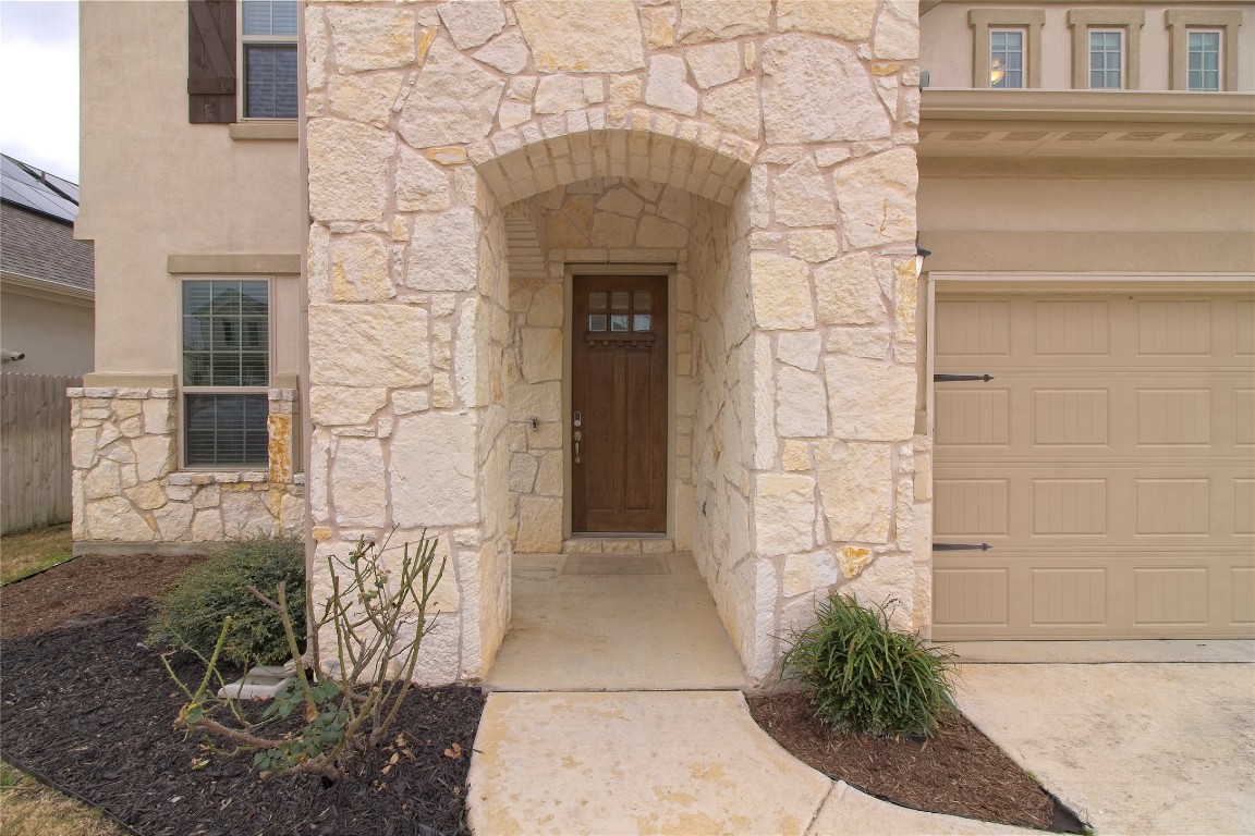 324 Windom Way Georgetown, TX 78626 - Photo 4 of 40 Property entrance featuring stone siding, a garage, and stucco siding