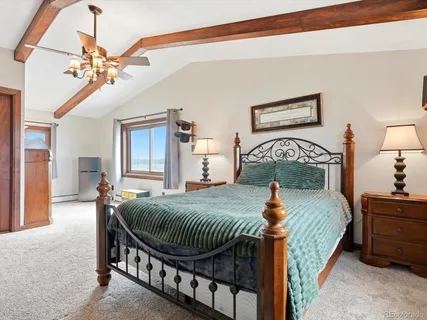 a bedroom with bed and a chandelier