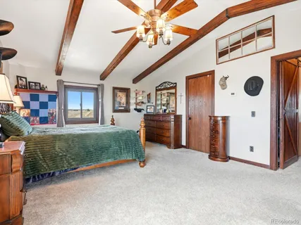 a bedroom with furniture and a mirror
