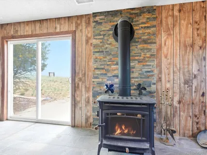 a living room with furniture a fireplace and a rug