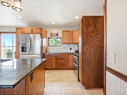 a kitchen with stainless steel appliances granite countertop a refrigerator and a sink