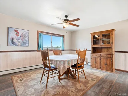 a view of a dining room with furniture and a chandelier