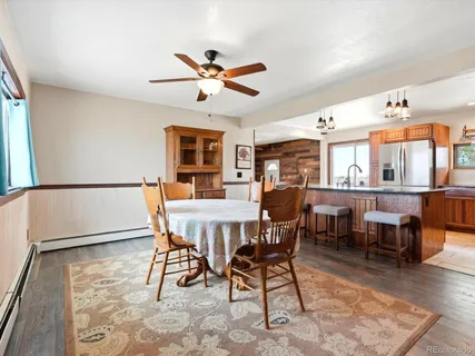 a dining room with furniture window and wooden floor