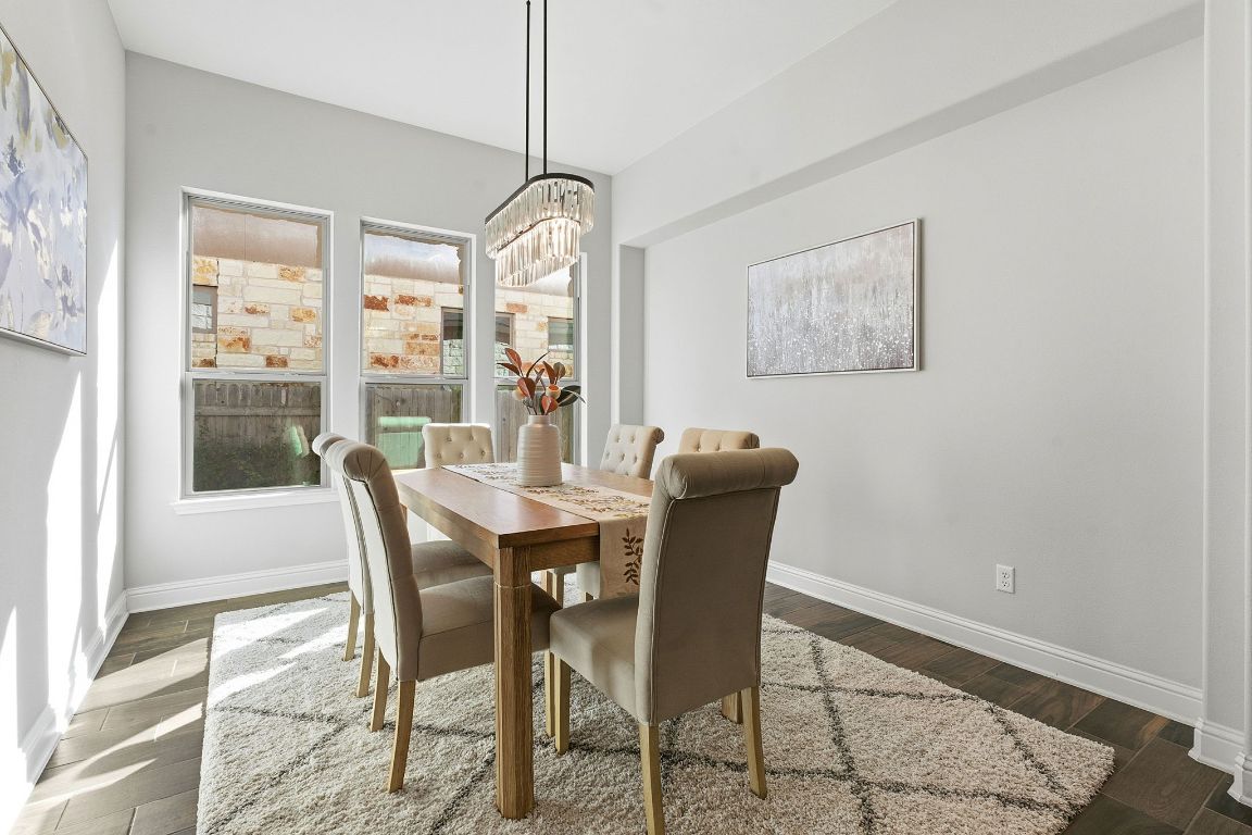 4020 Logan Ridge Drive Cedar Park, TX 78613 - Photo 16 of 40 Dining room with a chandelier and dark wood-type flooring