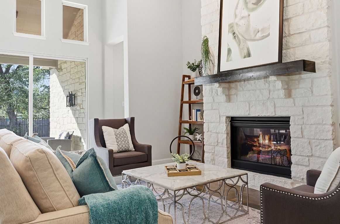 4020 Logan Ridge Drive Cedar Park, TX 78613 - Photo 10 of 40 Living room featuring a fireplace and a high ceiling