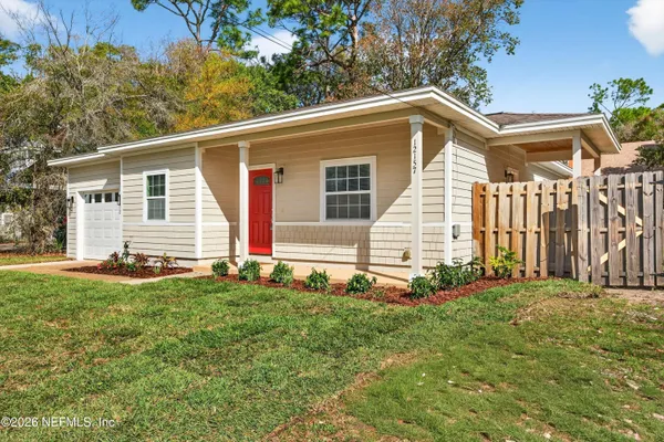 a backyard of a house with table and chairs