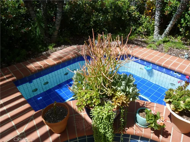 a view of a backyard with plants and outdoor seating