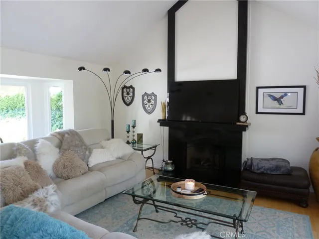 a living room with furniture wooden floor and a flat screen tv