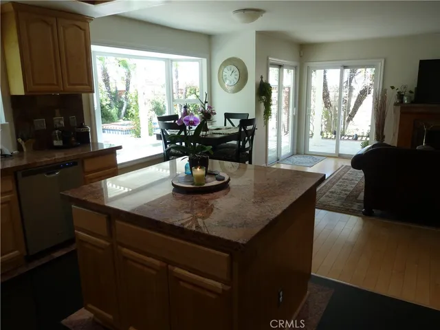 a dining room with furniture a large window and a fireplace