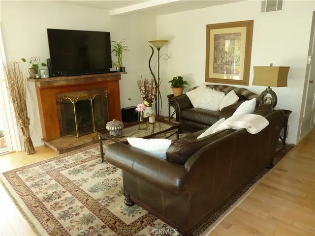 a living room with furniture fireplace and flat screen tv