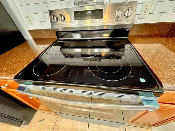 a stove top oven sitting inside of a kitchen
