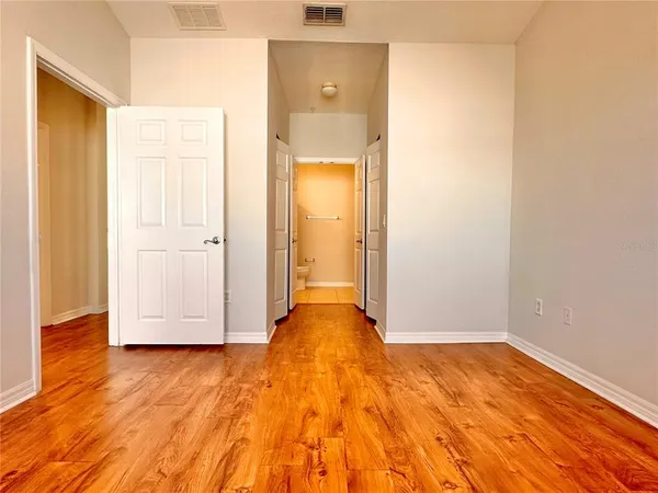 a view of a livingroom with wooden floor and a white door