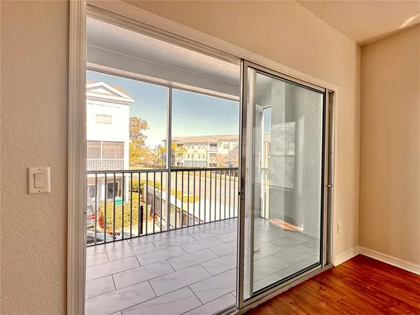 a view of a room with wooden floor and windows