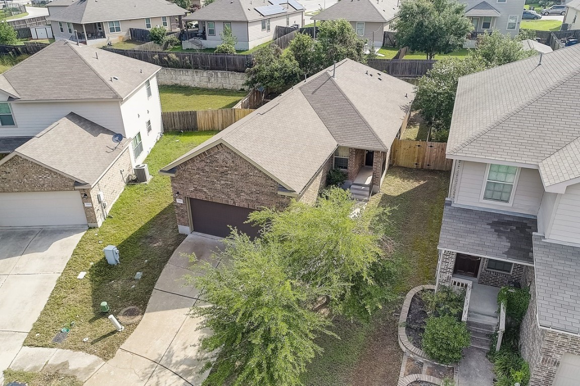 an aerial view of a house with a yard garden and outdoor seating
