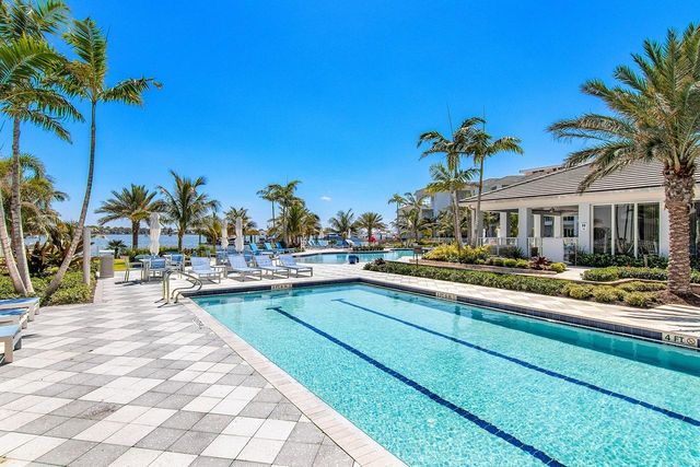 a view of swimming pool with outdoor seating and a patio