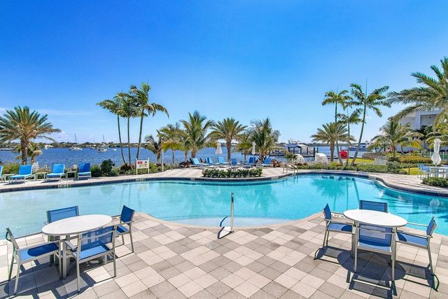 a view of a lake with chairs