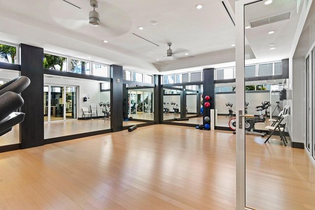 a lobby with furniture and a large window with wooden floor