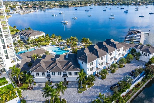 an aerial view of a house with a yard and lake view