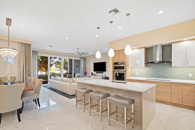 a large kitchen with a table and chairs in it