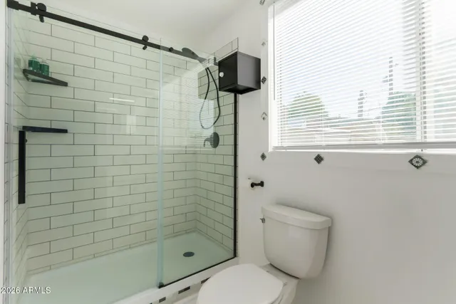 a bathroom with a toilet and shower