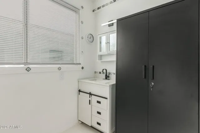 a bathroom with a sink a mirror and shower