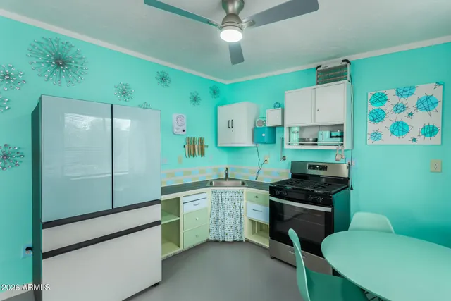 a kitchen with stainless steel appliances a sink cabinets and wooden floor